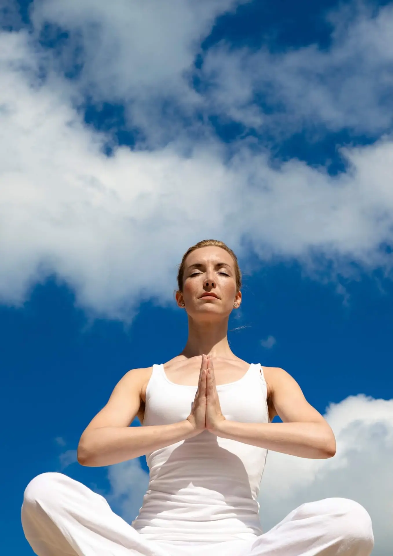 Woman practicing yoga, promoting physical benefits of meditation.