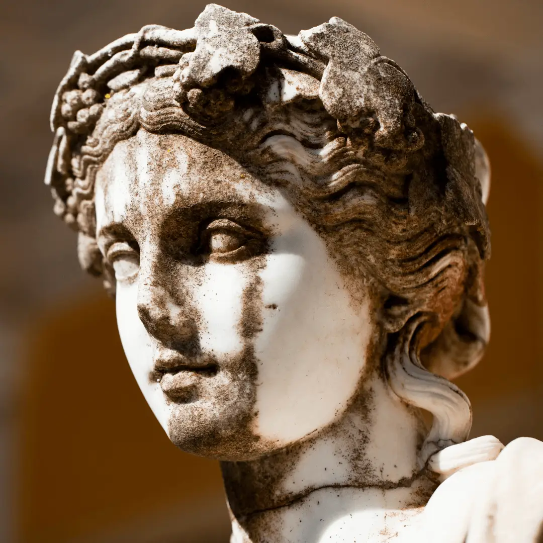 Statue of woman with wreath on head, symbolizing beauty ideals across history.