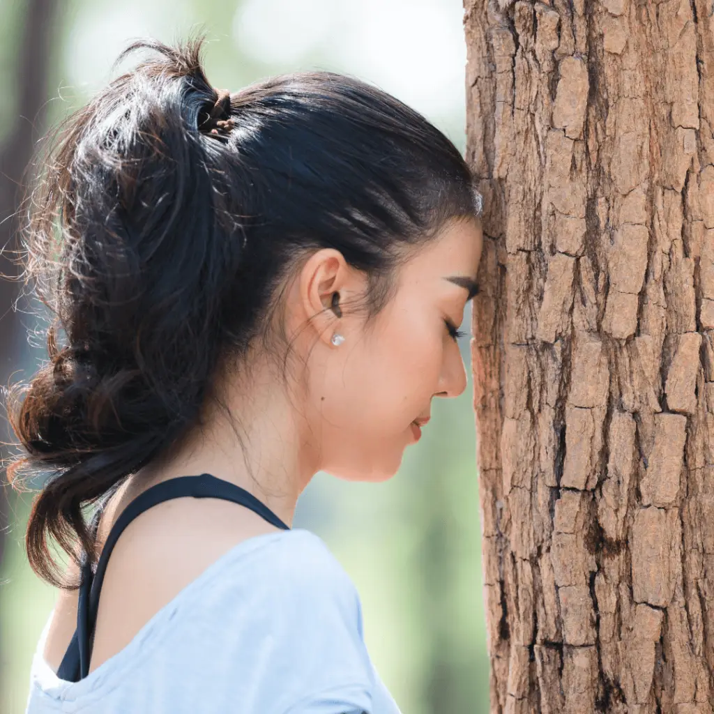 Image of a woman with a black ponytail engaging in a grounding exercise