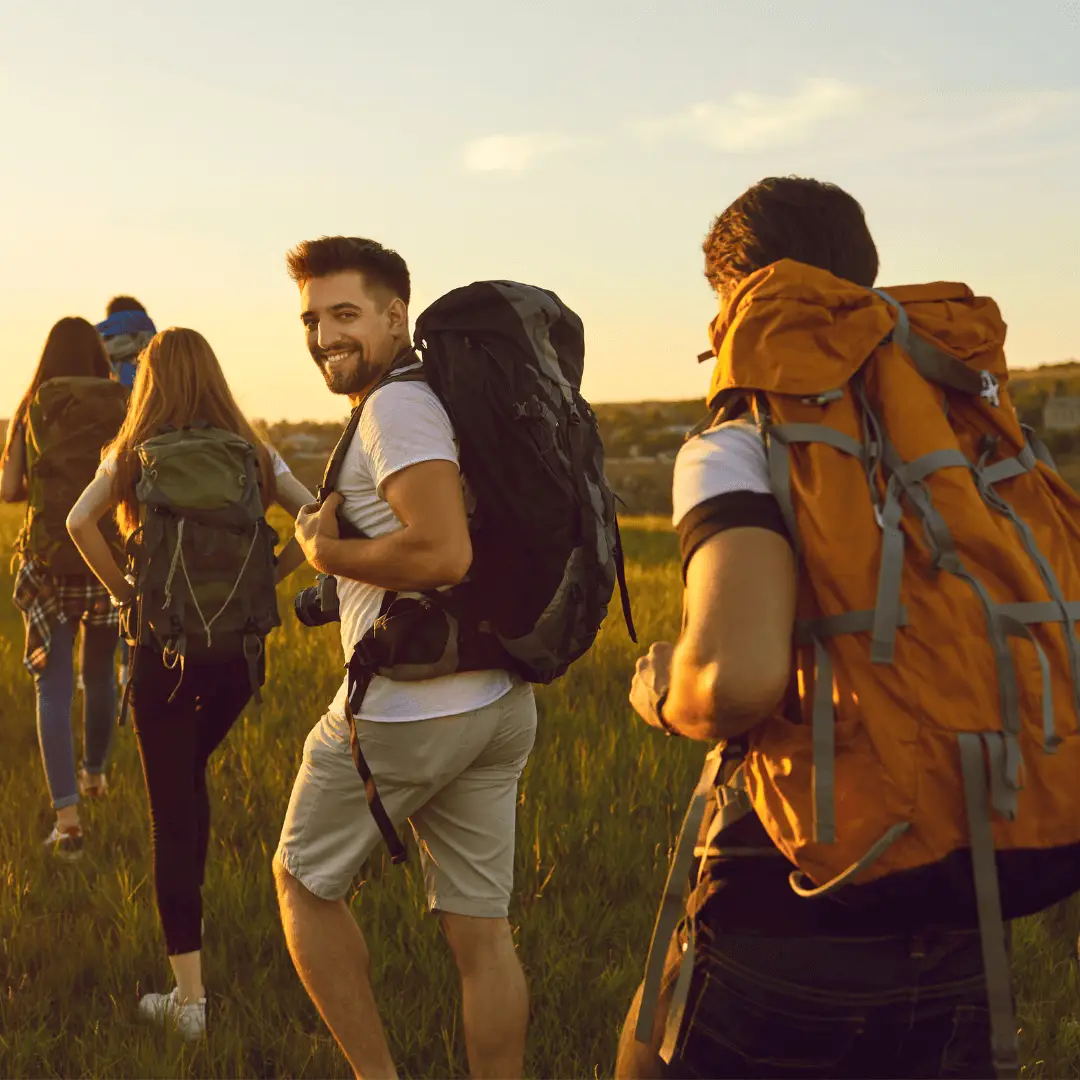 People of various ages and needs walking in a field, participating in a grounding exercise for overall well-being