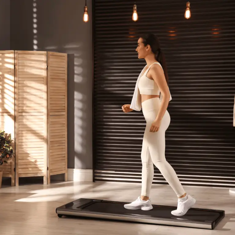 A woman participating in a 28-day indoor walking challenge, walking on a treadmill in a room.