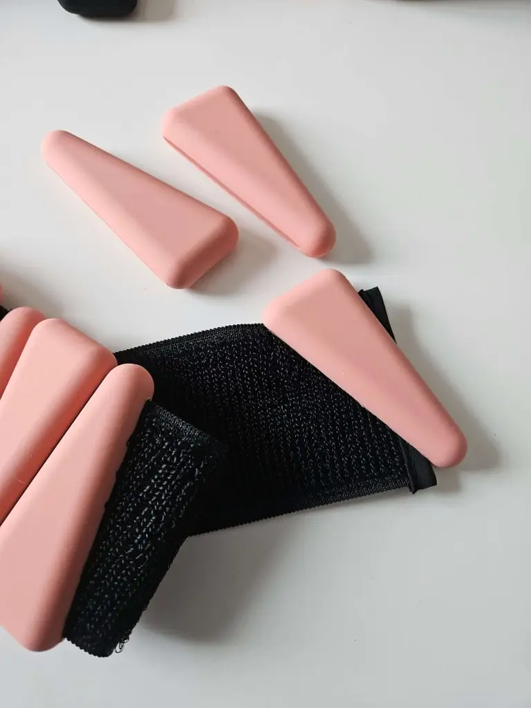 A wristband with pink and black straps.