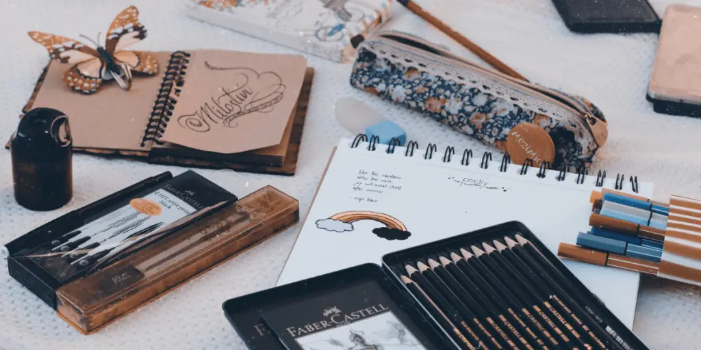 A collection of pens, pencils, notebooks, and more, promoting healing through art.