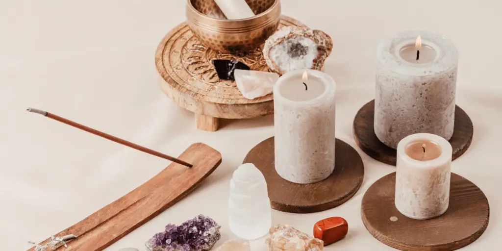 A table adorned with candles, incense sticks, and various items, creating a serene ambiance for Reiki Healing, a journey for balance.