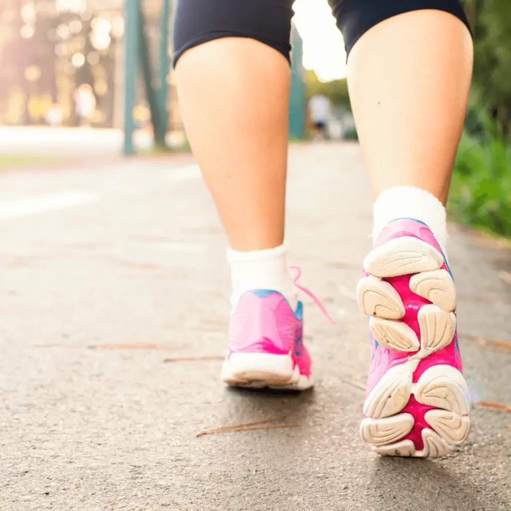 Person walking on paved road during indoor walking challenge.