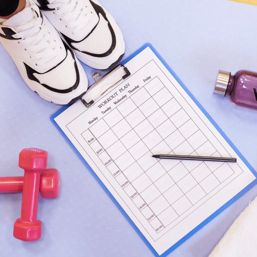 A fitness planner with a pen and a bottle of water, perfect for tracking progress during a walking challenge.