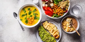 A selection of vegan meals in bowls on a table, introducing a new recipe.