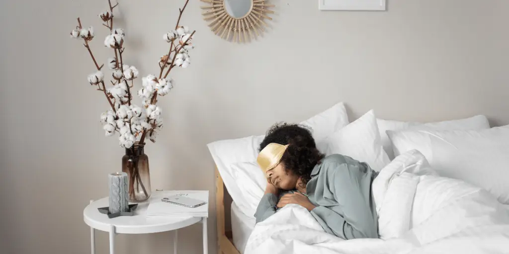A woman peacefully sleeping in bed with a pillow during slow wave sleep.