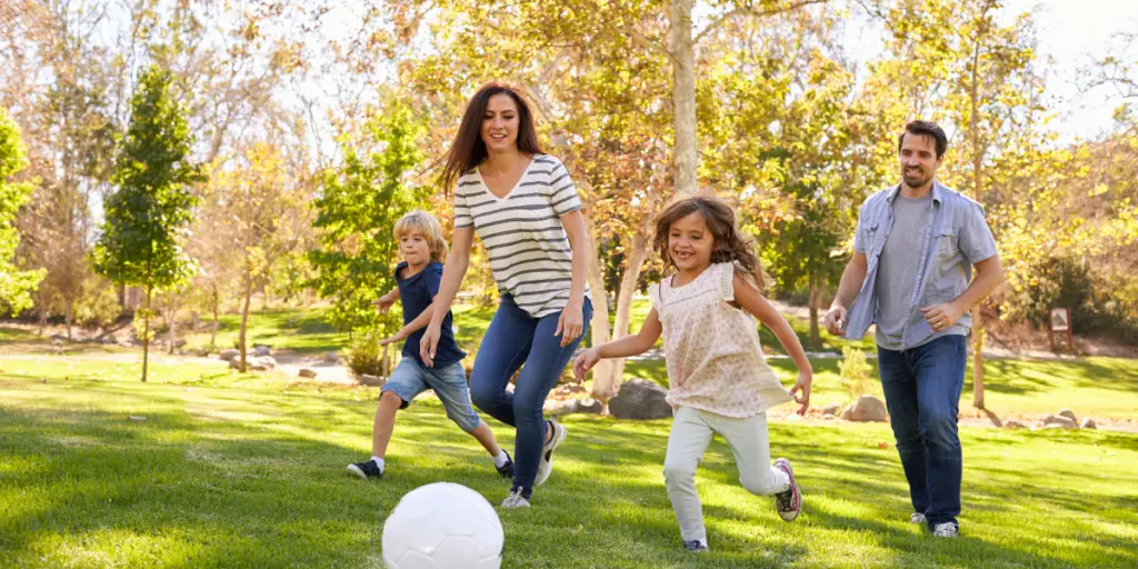 Promoting physical fitness and family fun with a white ball game in the park for Games for Health.