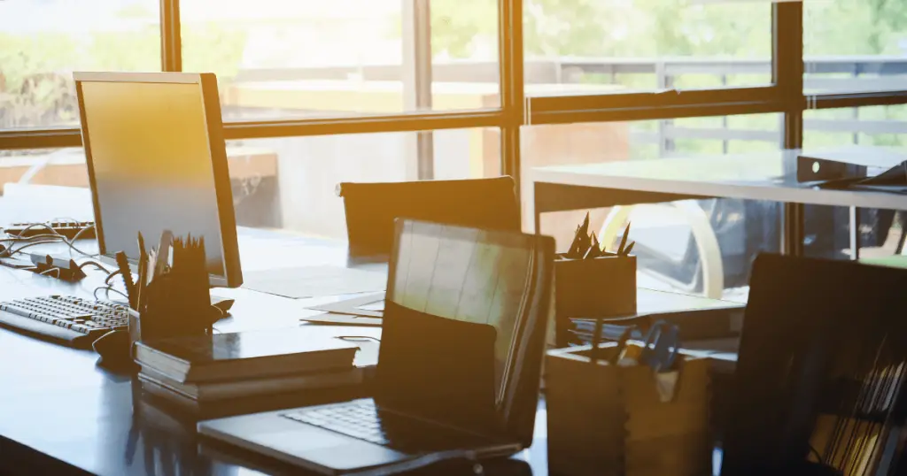 A modern office featuring a desk and computer monitor, promoting a healthy and productive workplace environment.