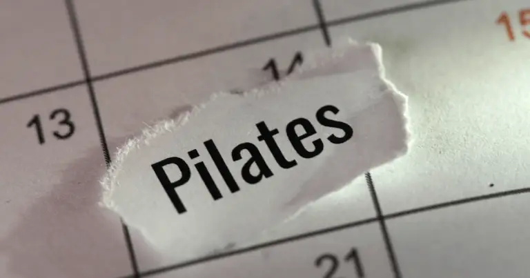 A person performing wall pilates, showcasing strength and flexibility in a serene studio environment.