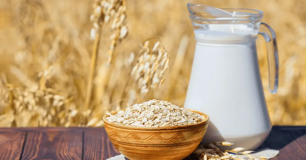 A bowl of oats and milk placed on a rustic wooden table, highlighting DIY beauty hacks with oatmeal milk.
