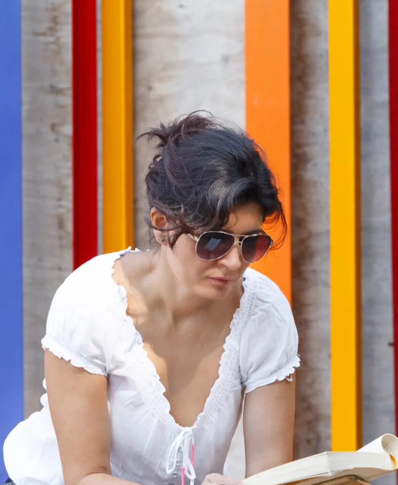 A stylish woman wearing sunglasses, exuding confidence and elegance.